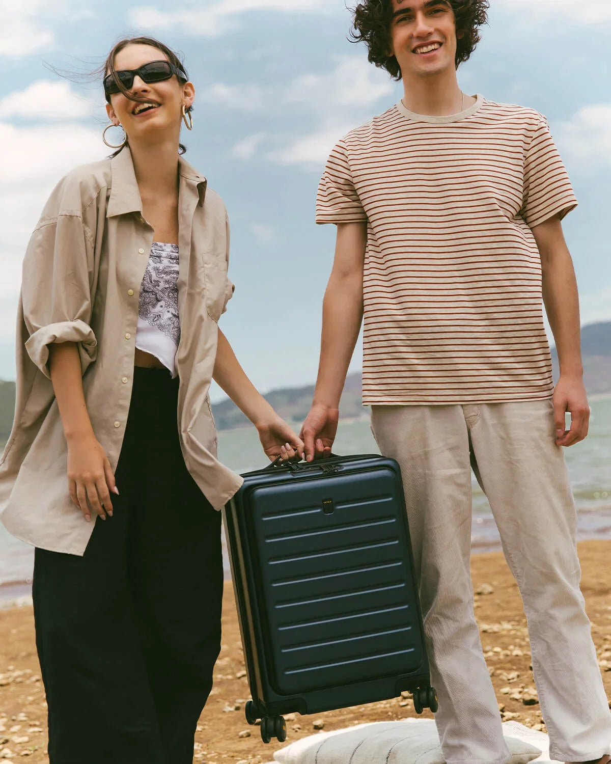 Couple traveling with luggage for a beach trip