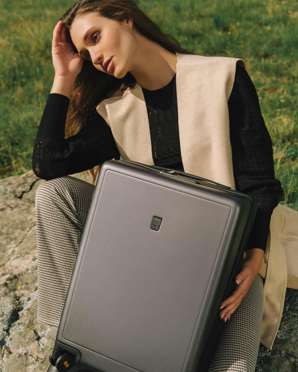 LEVEL8 Luminous Texture 20" suitcase in the hands of a female model.